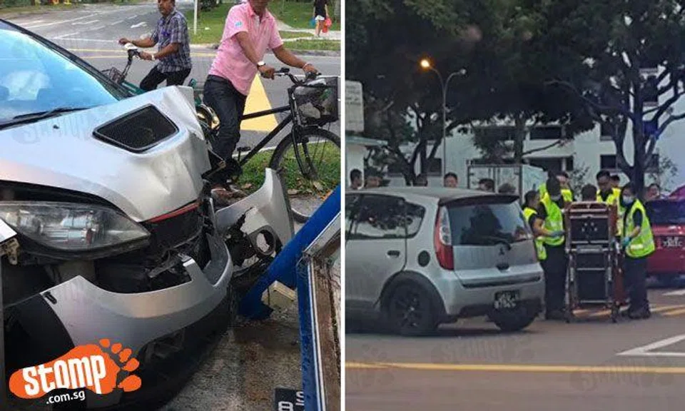 Mitsubishi driver crashes into signpost while trying to avoid turning SBS double-decker bus along Sims Drive
