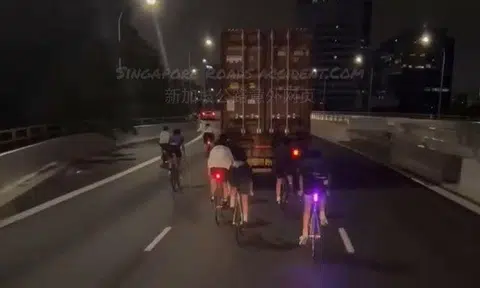 Cyclists without helmets tailgate truck on West Coast Highway