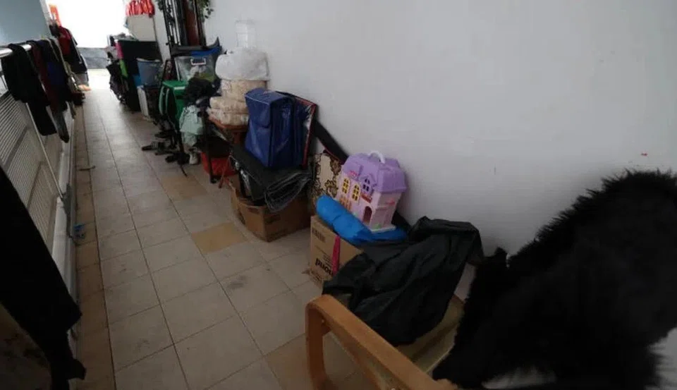 Items crowding the corridor, forcing neighbours to squeeze through when passing by.