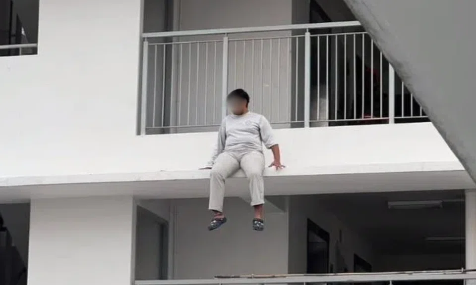 A man was arrested after being found sitting precariously on a HDB ledge.