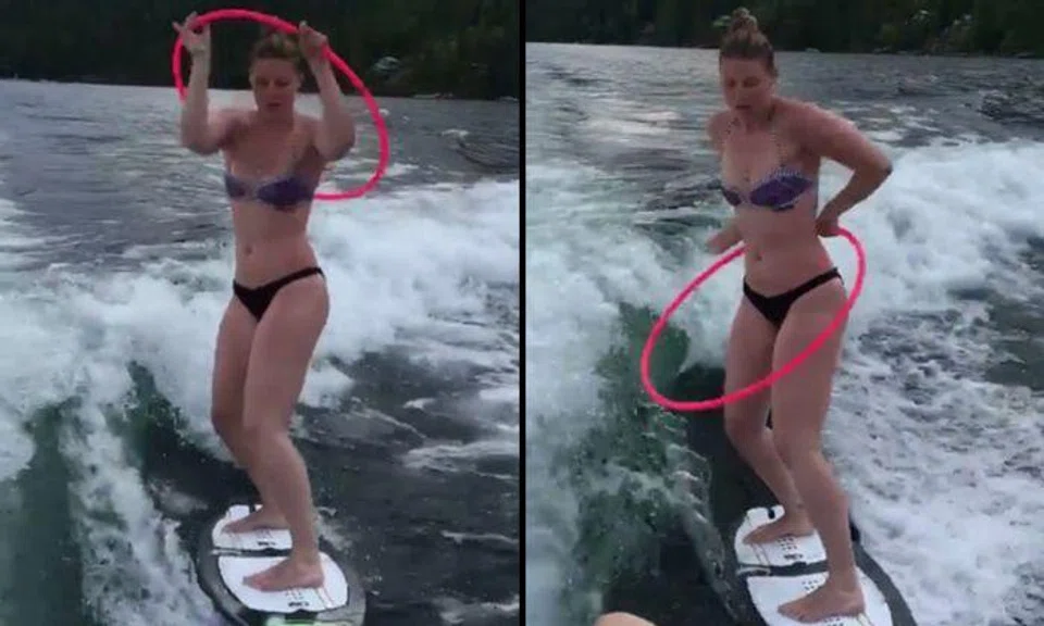 Bikini babe surfs while doing hula hoops -- and makes it look so easy