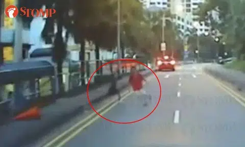 Kids playing with traffic cone and running around road risk being knocked down