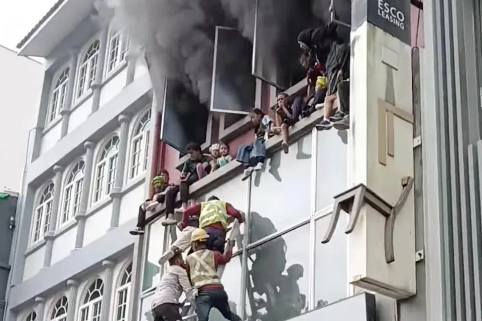 Children can be seen sitting on the ledge, waiting to be rescued.