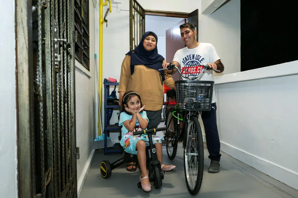 Ms Norharyani Jasman with her husband Muhammad Asif and their daughter outside their home at Block 313 Hougang Avenue 5 on March 13.