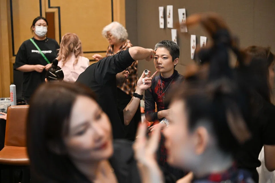 Mr Alif Alwee, a Mac and Bobbi Brown education lead, applying make-up on Ms Andrea Lim.