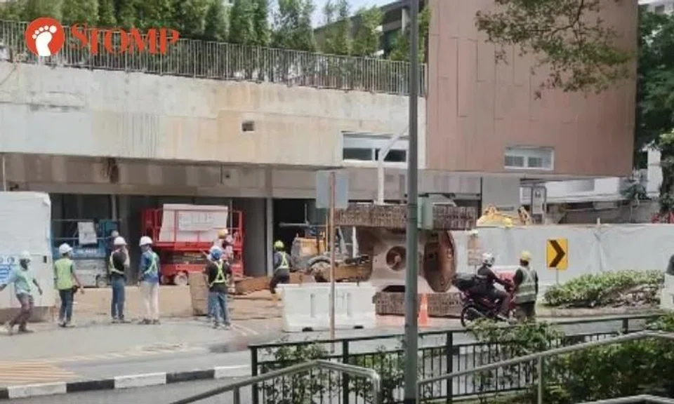 Excavator falls off trailer truck outside Bedok condo construction site