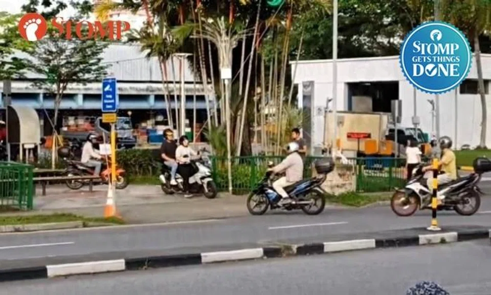 Motorcyclists ride on footpath to bypass parking gantry at Marsiling market, LTA taking them to task