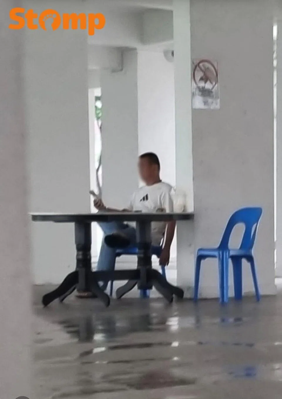man smoking at HDV void deck