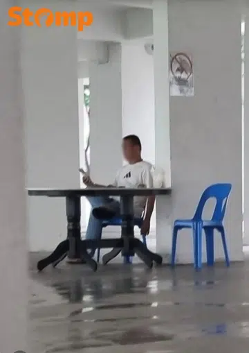 man smoking at HDV void deck