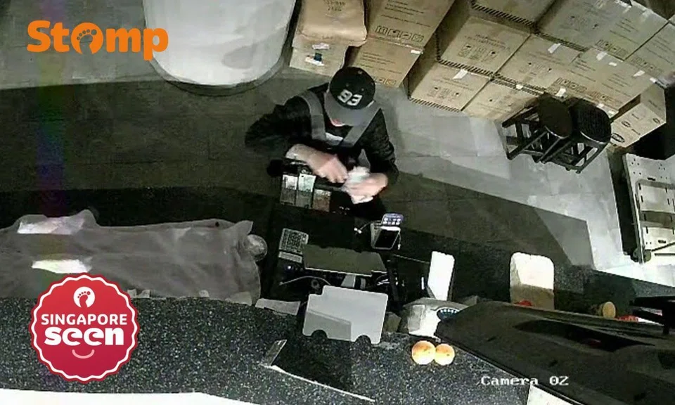 man takes money from cashier at Local Coffee People CIMB Plaza