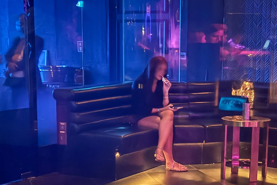 A woman vaping in a smoking room at Marquee on Aug 22.
