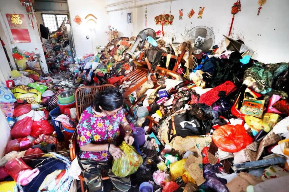Surrounded by piles of junk, Ms Chen says she sleeps on a rattan chair in the living room — the only space left in her cluttered flat.
