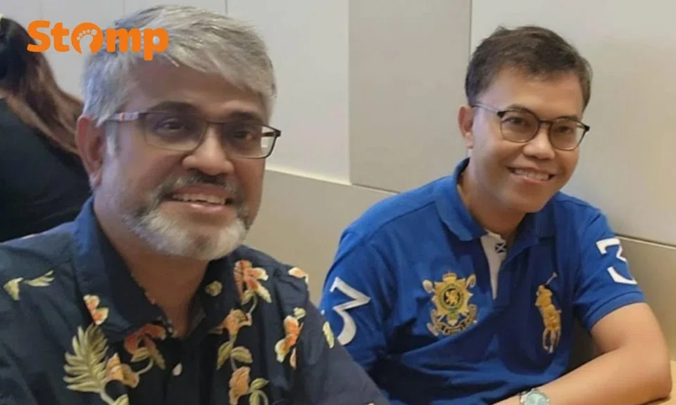 Two men in glasses smiling