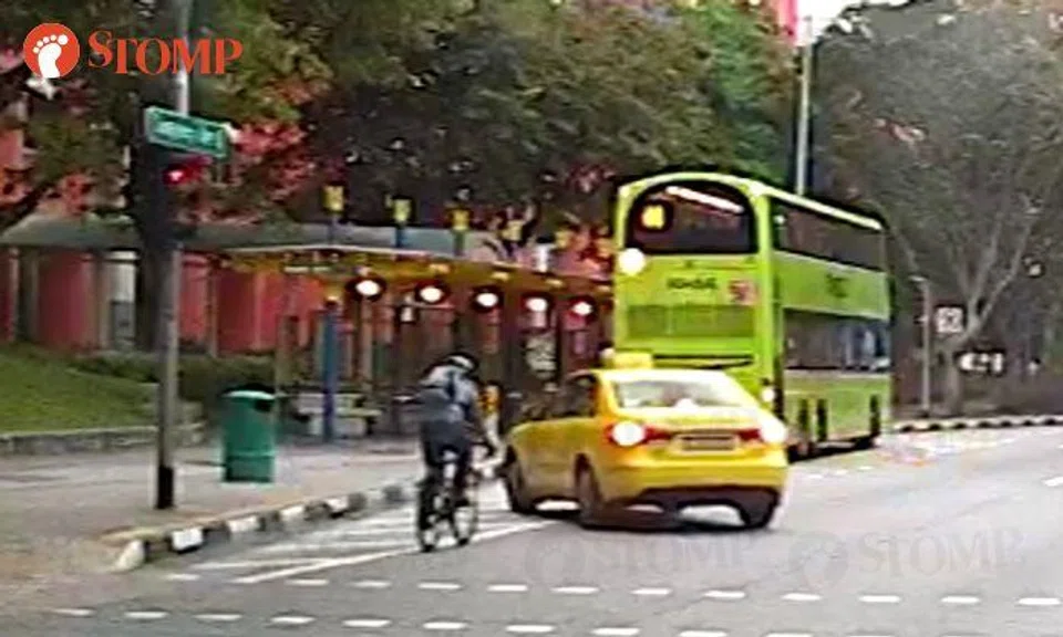 'Indecisive' cabby nearly hits cyclist with sudden turn towards bus stop at Tampines