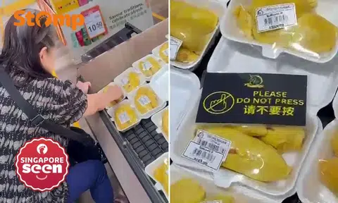 Woman pinches durian at FairPrice Finest The Seletar Mall