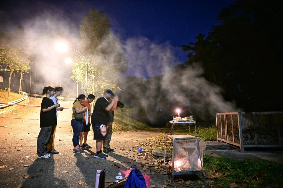 Participants being led by their guides to pay respects to the spirits in the area as they stand outside the old Changi Hospital during a session of Walk with Hantu: Changi in July 2024.