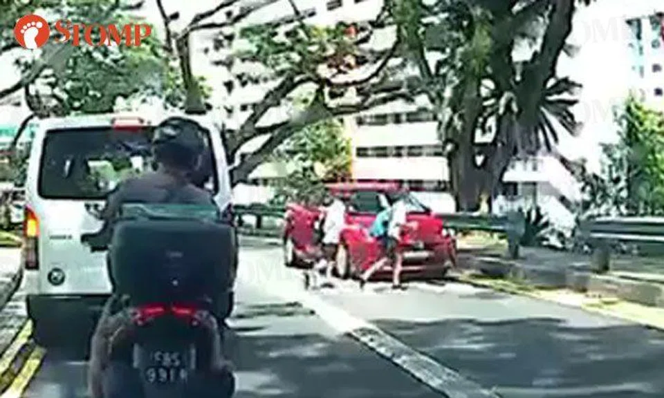 Students dash across Ang Mo Kio Avenue 4 and narrowly avoid getting hit by car