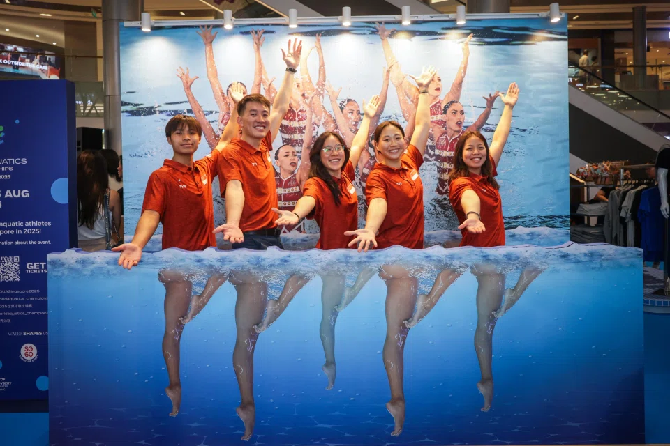 (From left) Singapore water polo players Cayden Loh, Lee Kai Yang, Abielle Yeo, Rochelle Ong and Nicole Lim posing at the artistic swimming trick-eye photo booth at the World Aquatics Championships Community Roadshow in ION Orchard on May 9.