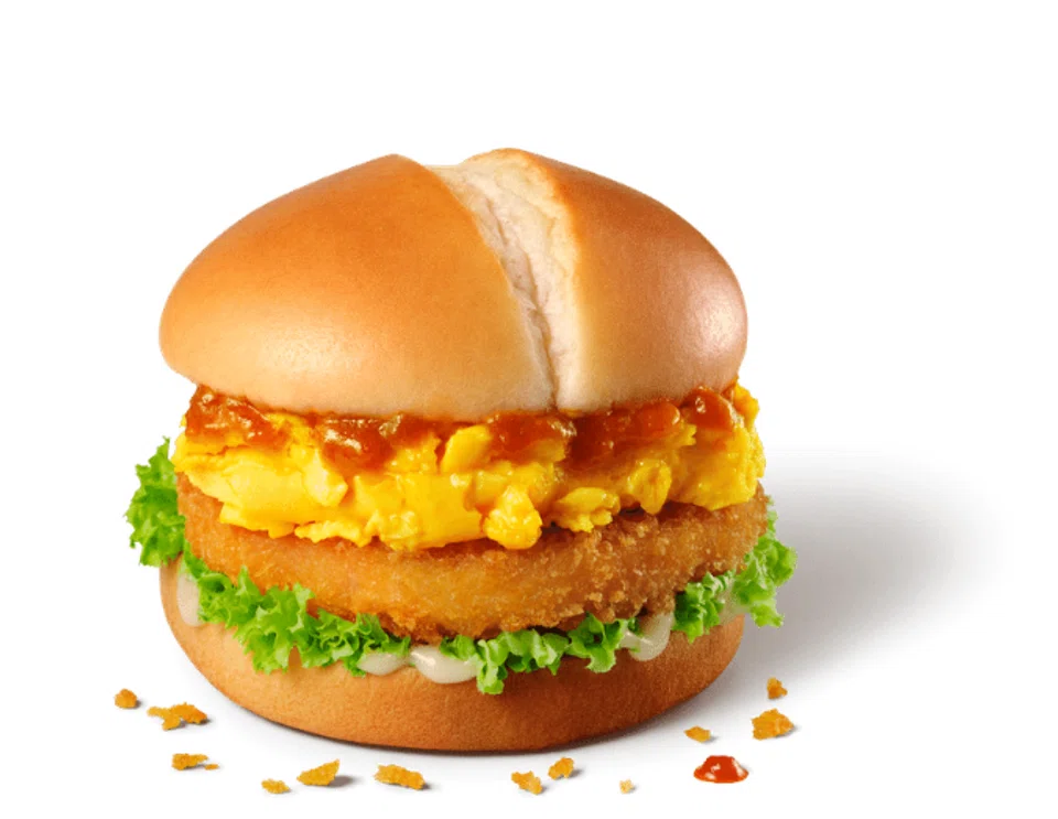 The Chilli Crab Sauce Prawn Burger features a prawn patty topped with a fluffy scrambled egg and lathered with chilli crab sauce. 