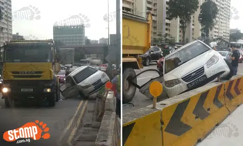 Car mounts temporary road barrier on Braddell Rd