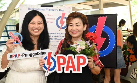 Pasir Ris-Punggol GRC MP Yeo Wan Ling (left) and a resident at an event marking International Women's Day on March 30.