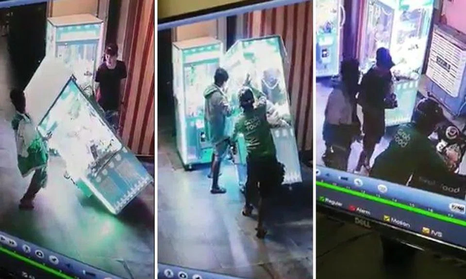 Men shake over 10 toys out of Clementi claw machine and hide them in food delivery bag
