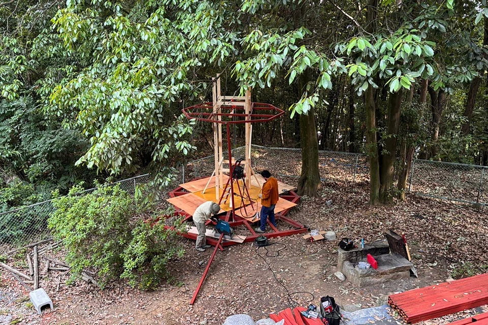 A friend of the couple and Mr Gwee working on an outdoor gazebo in May 2024.
