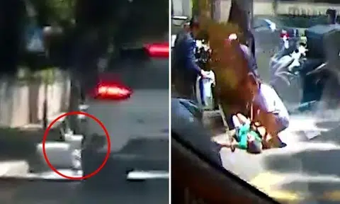 In the video, a silver taxi is seen driving towards a zebra crossing before hitting the woman.