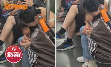 Mother trim daughter’s fingernails on MRT