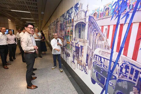 Minister of State for Transport Baey Yam Keng (left) looking at the commemorative artwork titled Seeing History Through The Bamboo Forest' at Little India MRT station with artist Yeo Siak Goon on Oct 21.