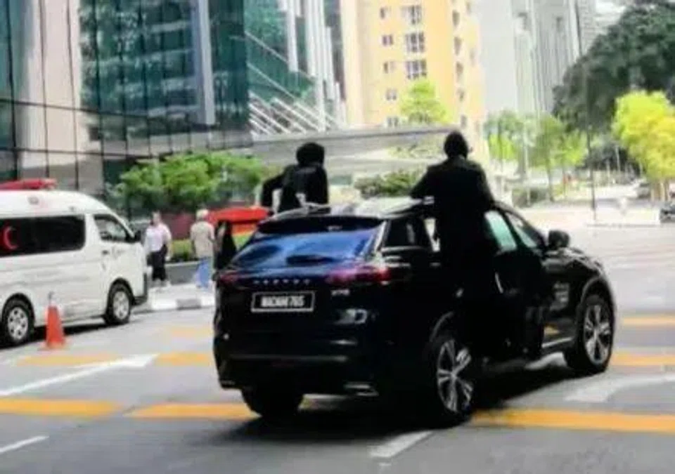Two Malaysian female bodyguards were seen leaping onto a moving car while escorting delegates during the 47th Asean Summit.