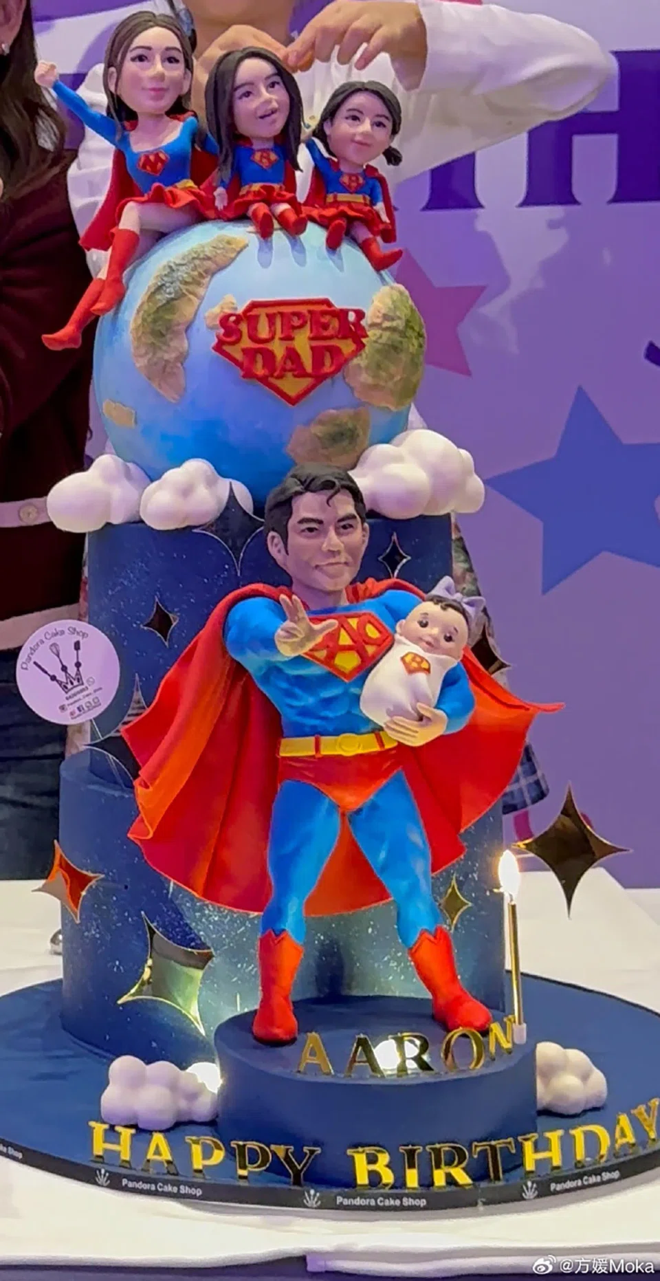 There was a photo of a Superman-themed cake featuring the family of five as Superman, Superwoman and Supergirl. PHOTO: MOKA FANG/WEIBO