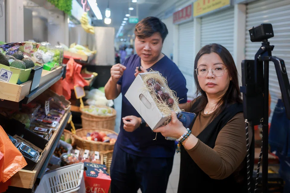 Ms Christina Gwee selling fruit from Tiong Bahru Market on a shopping live stream.