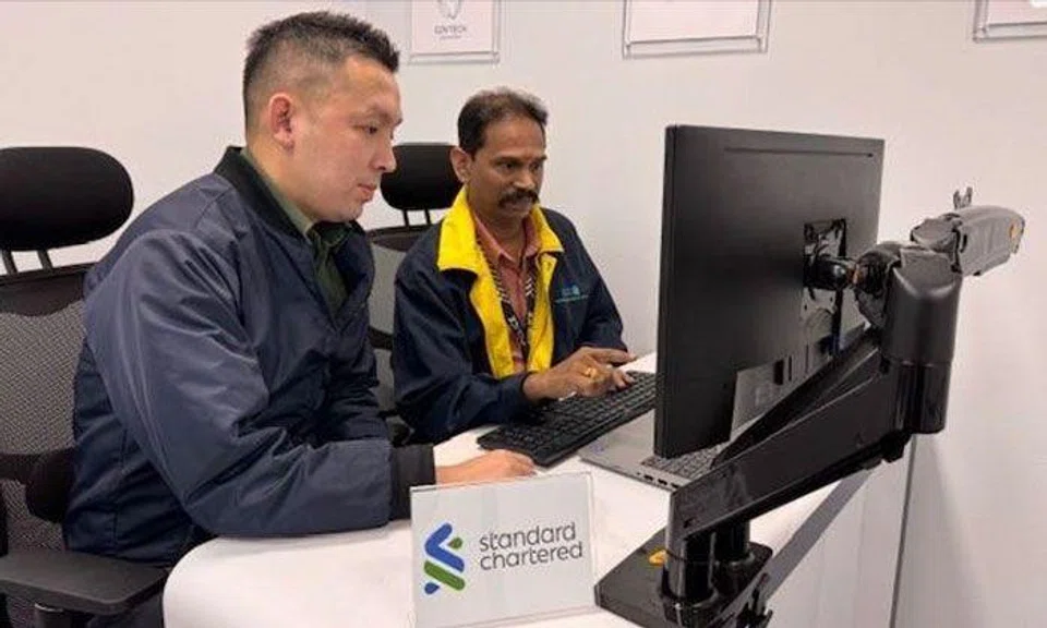ASP Chu Kok Min (left) and Mr Rajendaran, Manager, Fraud Risk Management, at Standard Chartered Bank (right), worked together to prevent the potential loss of $200,000 by a job scam victim. PHOTO: SPF