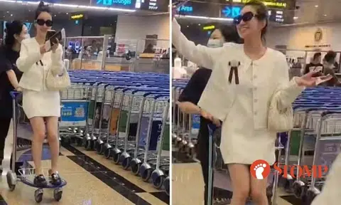Grown woman sits on luggage trolley and takes selfie while being pushed around at Changi Airport