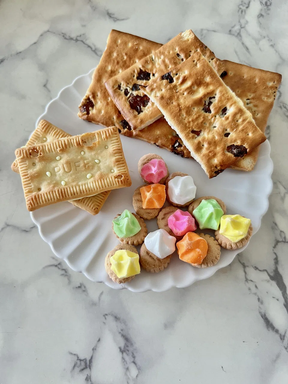 Khong Guan's popular (clockwise from left) Lemon Puffs, Sultana Biscuits and Fancy Gems.