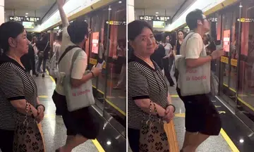 man dancing in crowded china metro station