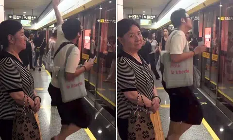 man dancing in crowded china metro station