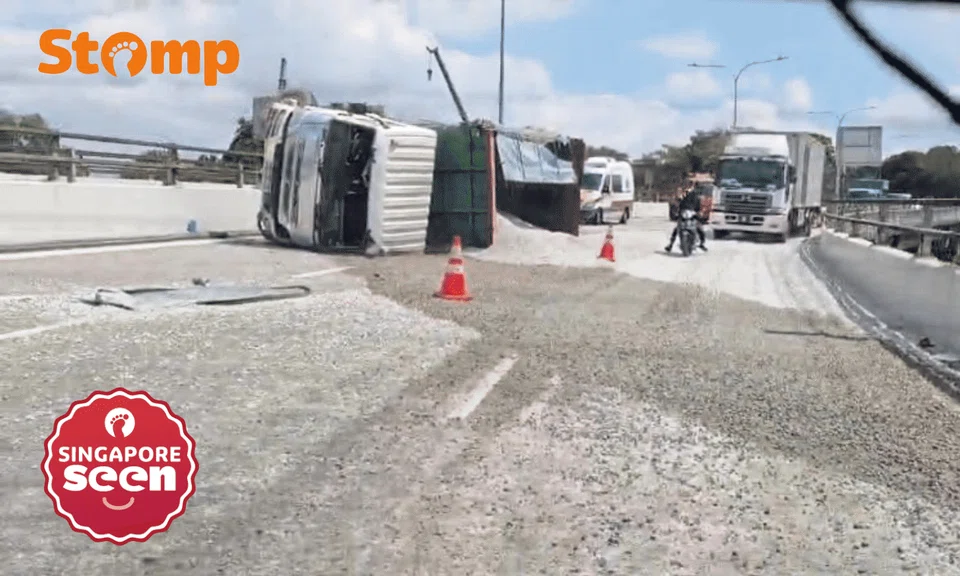 Lorry overturns on SLE slip road to old Turf Club, driver assisting with police investigations