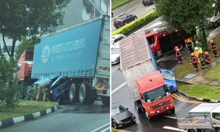 Driver trapped after taxi gets wedged between container lorry and kerb ...