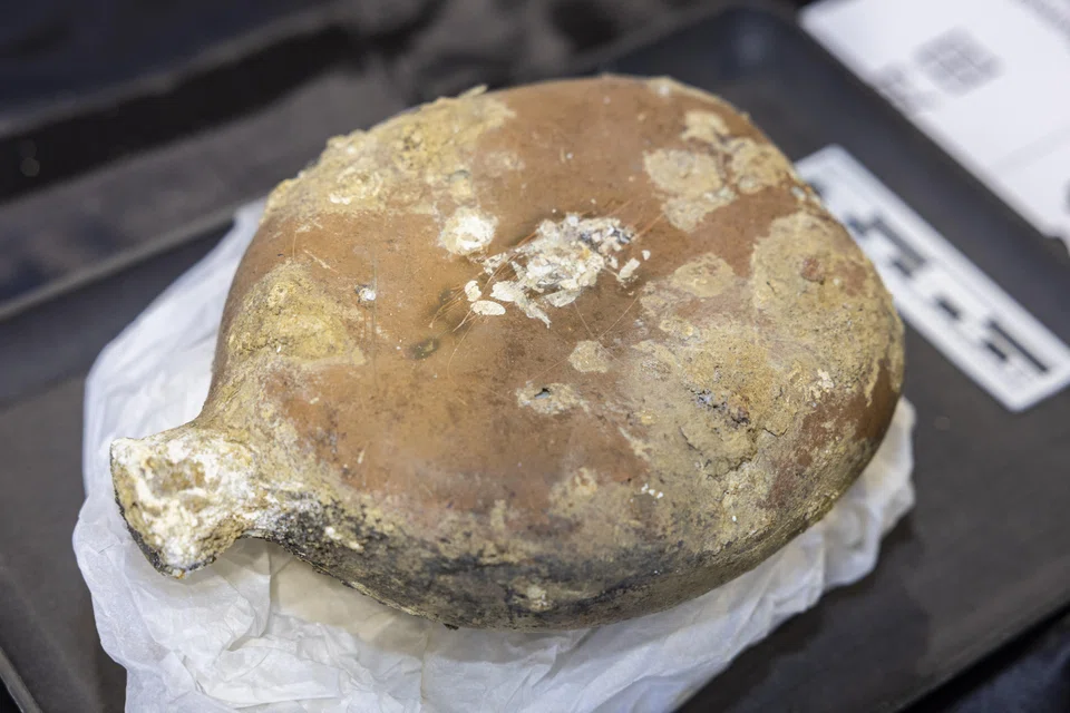 Close-up of a Japanese army type 94 water bottle that was found, marked with its owner's initials.