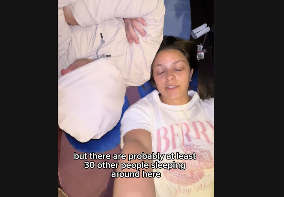 The couple found a spot at a "sleeping village" at what appears to be Terminal 1.