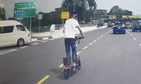 Watch how e-scooter rider with a death wish 'nearly became roadkill ...