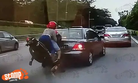 Pillion rider lies on road after bike collides with car on BKE