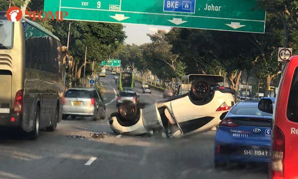 Car turns turtle on SLE, driver declines to be taken to hospital