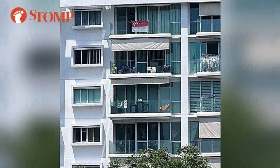 A Stomper shared a photo of the green-and-white flag two stories below a red-and-white Singapore displayed at the same building.