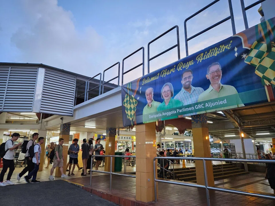 A banner of Workers' Party members Faisal Manap, Sylvia Lim, Pritam Singh and Gerald Giam at a walkway at Kovan Market and Food Centre.