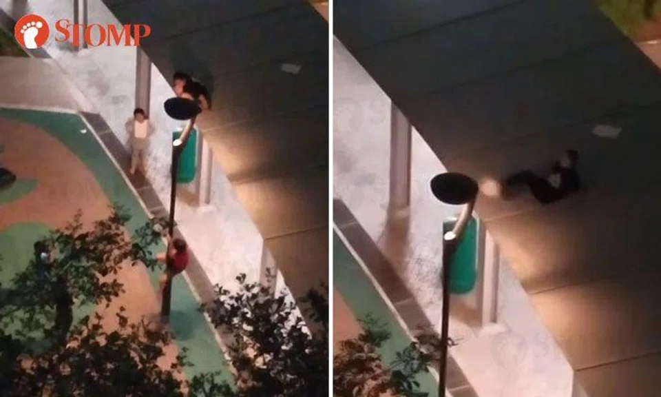 Youths climb up lamp post and play on walkway shelter at Punggol
