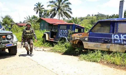 A government soldier patrols a deserted mountain village after pro-Islamic State militants, who had earlier taken over the village, had left, on the outskirts of Marawi city. Photo: Reuters