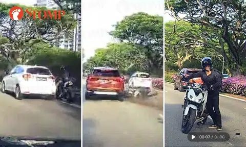 Motorcyclist squeezes between Honda car and road divider, skids into BMW on ECP and walks away